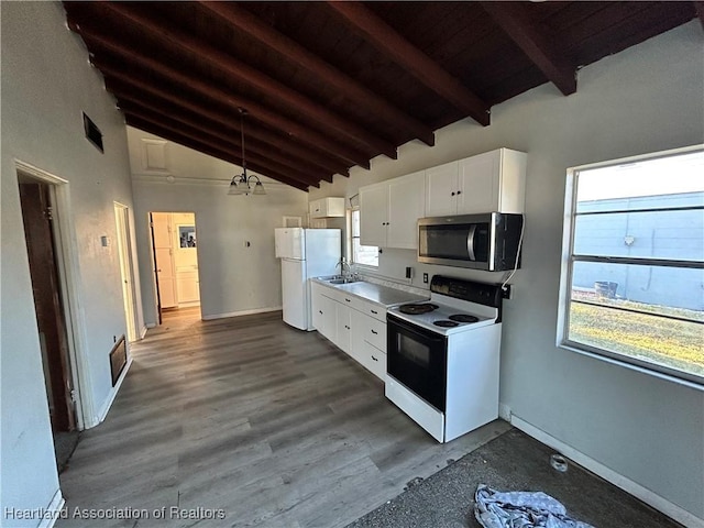 kitchen featuring white appliances, sink, dark hardwood / wood-style floors, beam ceiling, and white cabinetry