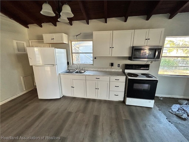 kitchen featuring a wealth of natural light, sink, white cabinets, and white appliances