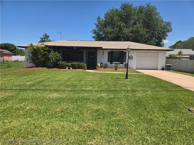 ranch-style home featuring a garage, a front yard, driveway, and fence