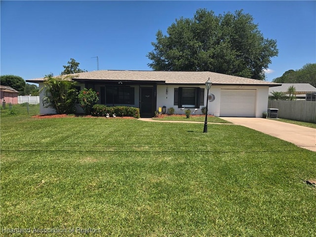 ranch-style house with a garage, concrete driveway, fence, stucco siding, and a front lawn