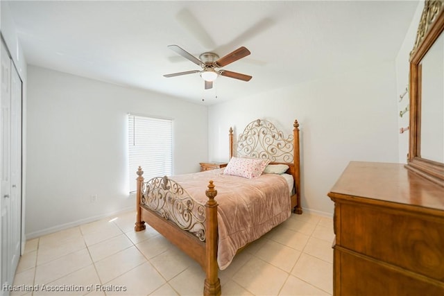 bedroom with ceiling fan, baseboards, a closet, and light tile patterned flooring