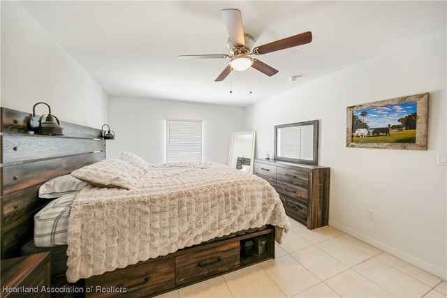 bedroom with baseboards, a ceiling fan, and light tile patterned flooring