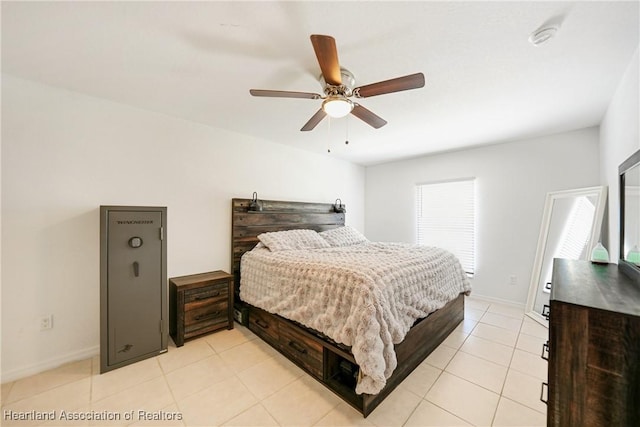 bedroom featuring ceiling fan, light tile patterned floors, and baseboards