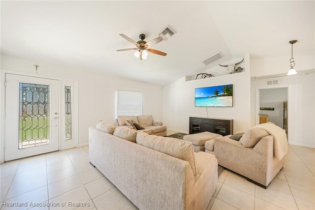 living room featuring lofted ceiling, ceiling fan, visible vents, and light tile patterned flooring