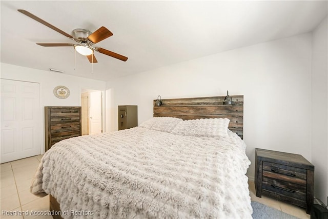 bedroom featuring a ceiling fan and light tile patterned floors