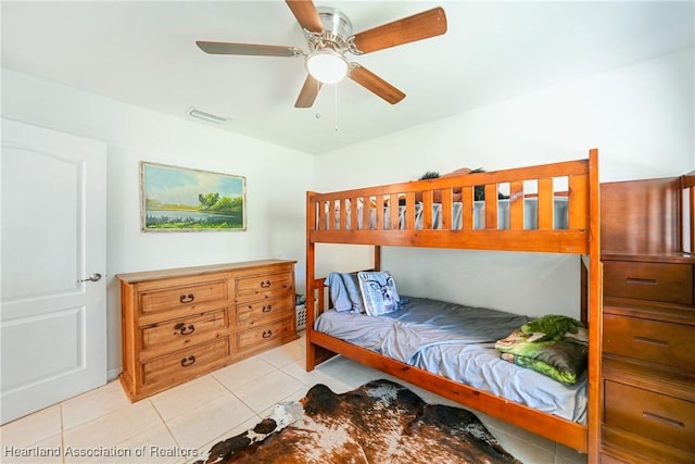 bedroom featuring a ceiling fan, visible vents, and tile patterned floors