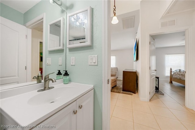 bathroom featuring vanity, ensuite bath, visible vents, and tile patterned floors