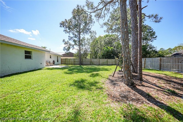 view of yard featuring a patio area and a fenced backyard