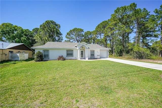 ranch-style house featuring a garage, fence, concrete driveway, stucco siding, and a front yard