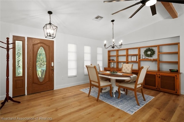 245 Lake Blvd, Sebring, FL 33875 - dining area with a chandelier, light wood-style flooring, ceiling fan, and lofted ceiling