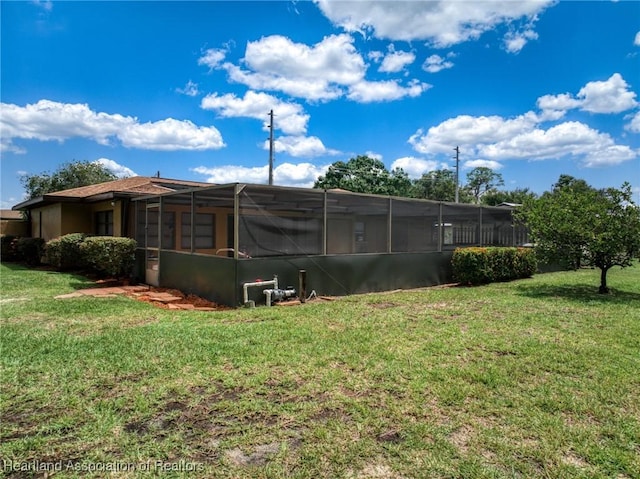 245 Lake Blvd, Sebring, FL 33875 - back of house with a yard and a lanai