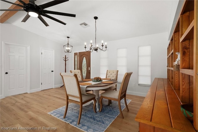 245 Lake Blvd, Sebring, FL 33875 - dining room featuring a chandelier, vaulted ceiling, light wood-style floors, and ceiling fan