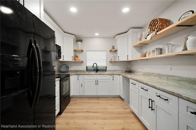 245 Lake Blvd, Sebring, FL 33875 - kitchen with black appliances, open shelves, white cabinetry, recessed lighting, and light wood finished floors