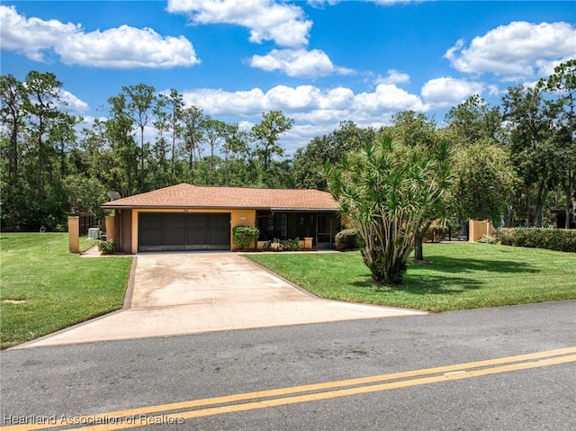 245 Lake Blvd, Sebring, FL 33875 - ranch-style house with an attached garage, a front yard, concrete driveway, and view of scattered trees