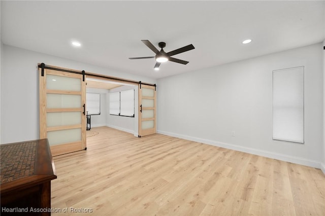 245 Lake Blvd, Sebring, FL 33875 - unfurnished room featuring a barn door, ceiling fan, wood finished floors, and recessed lighting