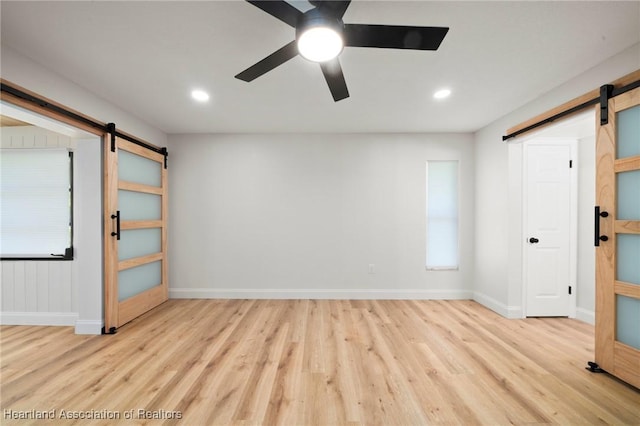 245 Lake Blvd, Sebring, FL 33875 - unfurnished bedroom with a barn door, wood finished floors, and recessed lighting