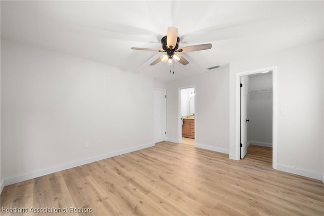 245 Lake Blvd, Sebring, FL 33875 - unfurnished bedroom featuring light wood-style floors, a walk in closet, connected bathroom, and a closet
