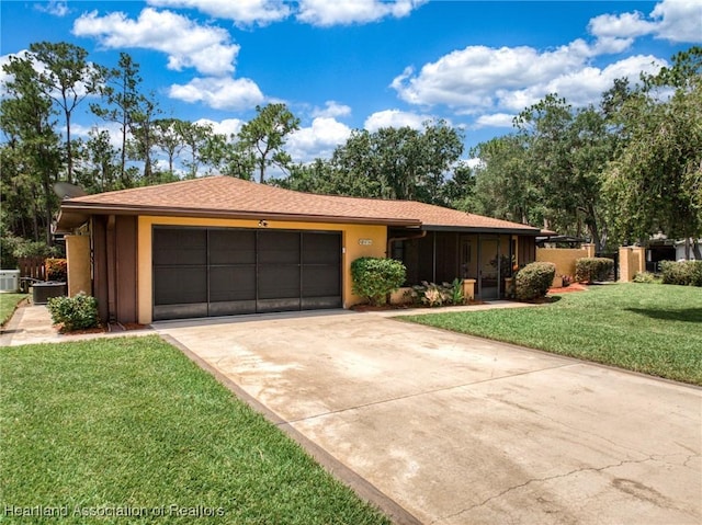 245 Lake Blvd, Sebring, FL 33875 - ranch-style home featuring a garage, driveway, a front yard, a sunroom, and stucco siding