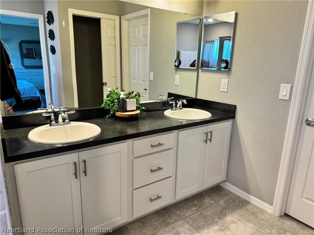 bathroom with tile patterned floors and vanity