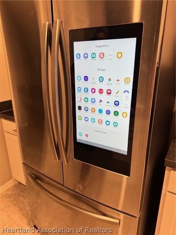 details with white cabinets and stainless steel fridge