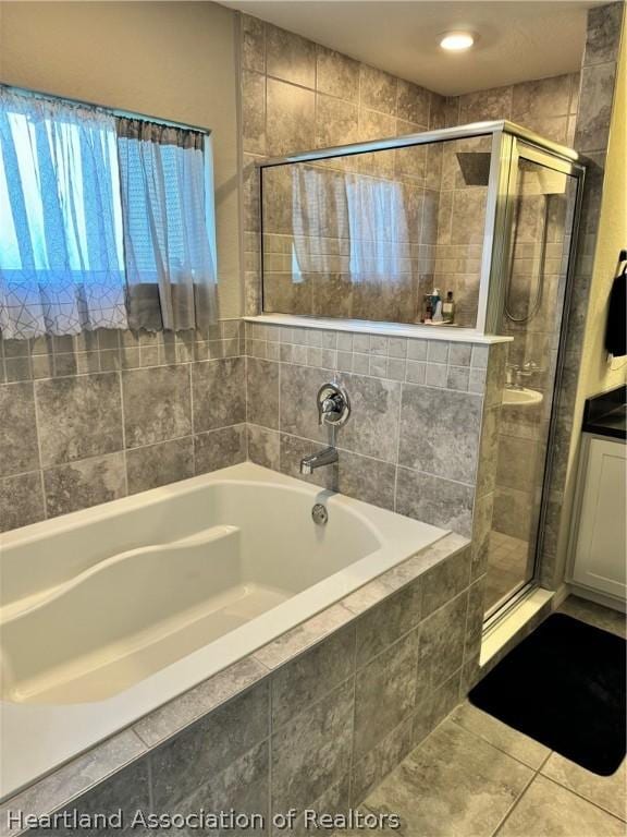 bathroom with tile patterned flooring and independent shower and bath