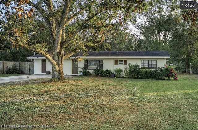 ranch-style house with a front lawn