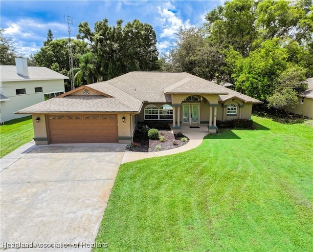 view of front of property with stucco siding, french doors, concrete driveway, an attached garage, and a front yard