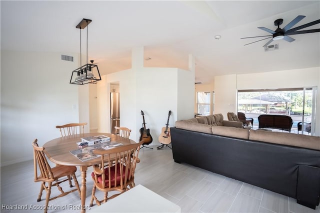dining space featuring visible vents, high vaulted ceiling, and ceiling fan