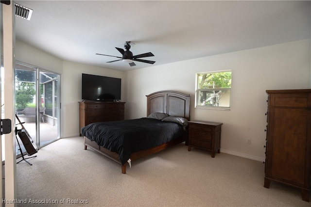 carpeted bedroom featuring access to exterior and ceiling fan