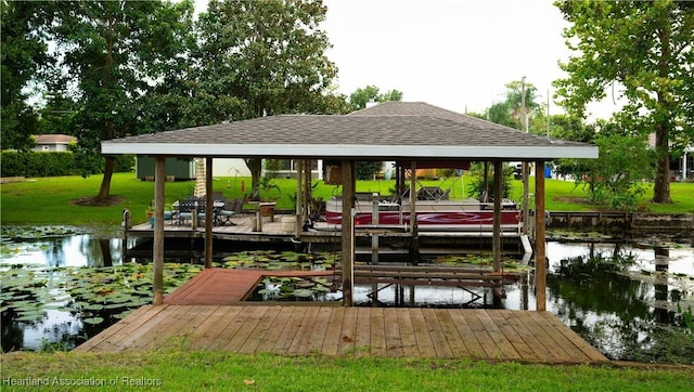 dock area featuring a water view and a lawn