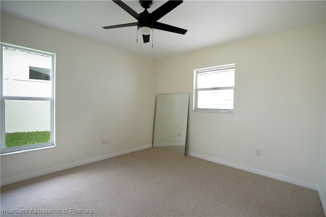 empty room with carpet flooring and ceiling fan