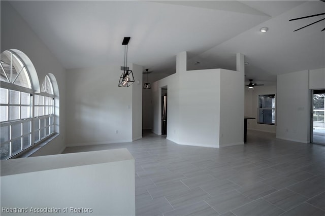 unfurnished living room featuring ceiling fan and vaulted ceiling