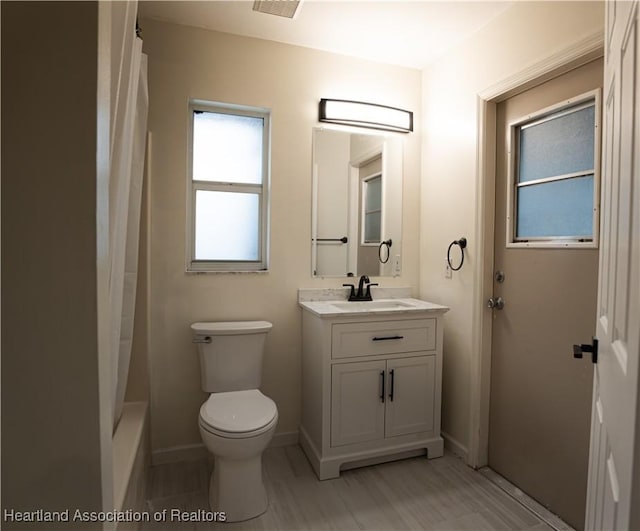 full bathroom with vanity, toilet, and shower / bath combo