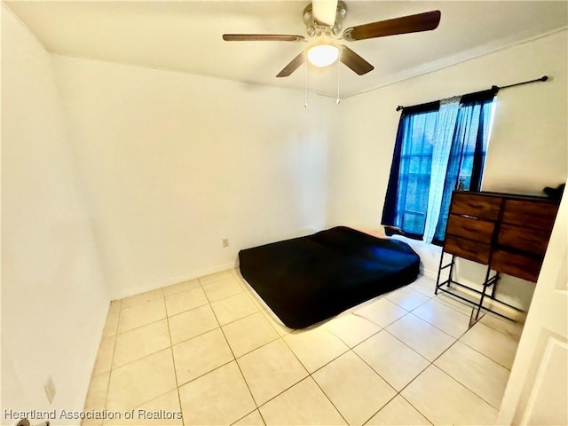 tiled bedroom featuring ceiling fan