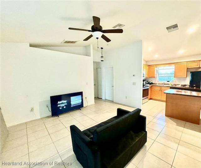 tiled living room featuring ceiling fan and lofted ceiling