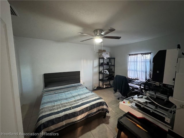 bedroom with ceiling fan and light tile patterned floors