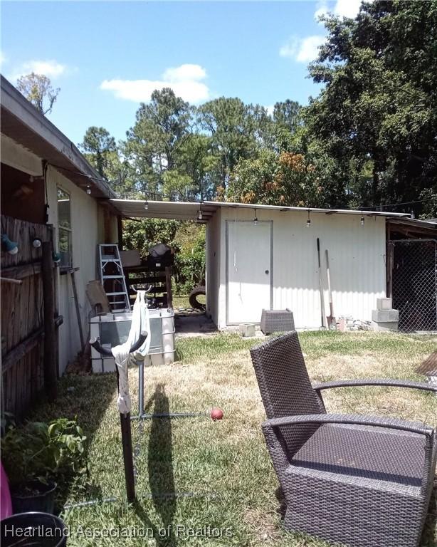 view of yard with an outdoor structure and a storage shed