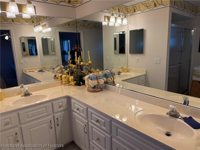 bathroom featuring vanity and a shower with door