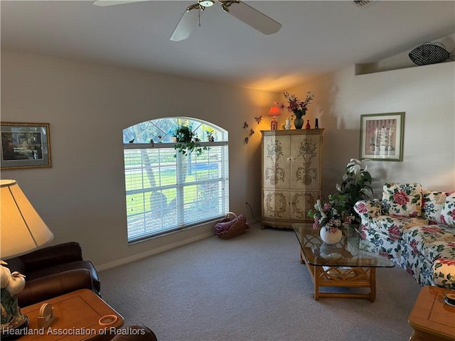 living room featuring carpet flooring and ceiling fan