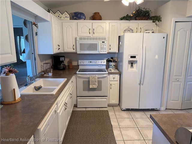 kitchen featuring white cabinetry, white appliances, sink, and light tile patterned floors