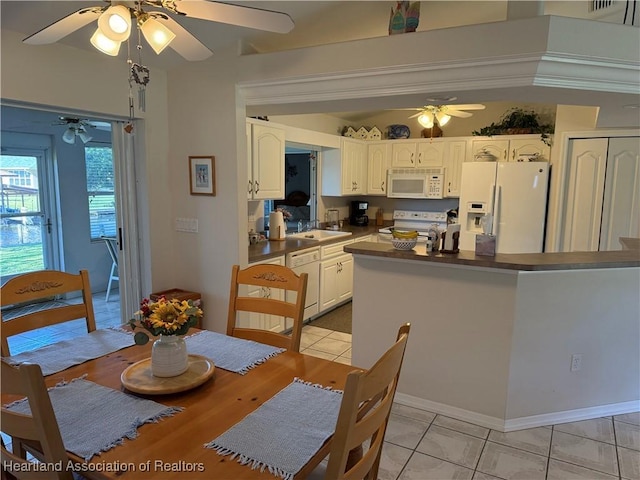 kitchen featuring white cabinets, white appliances, and light tile patterned flooring