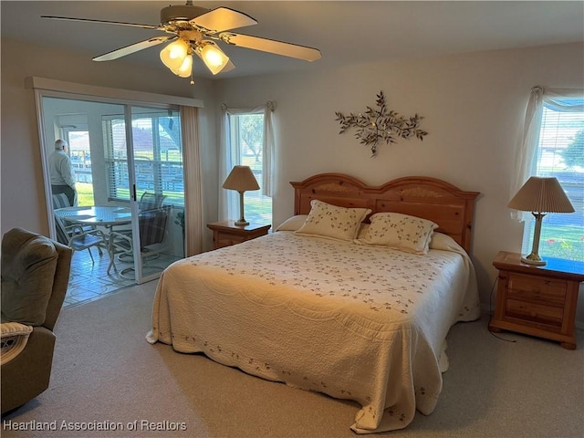 bedroom with access to exterior, light carpet, and ceiling fan