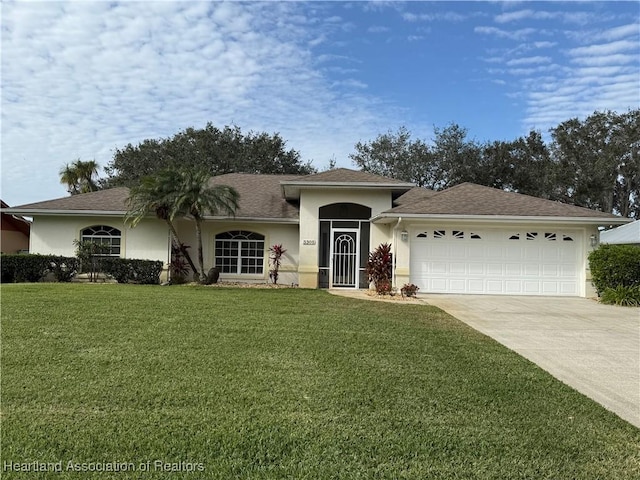 view of front of property with a garage and a front lawn