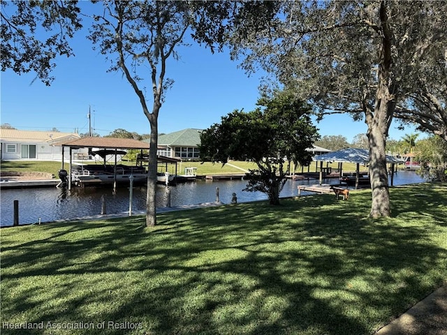 dock area with a yard and a water view