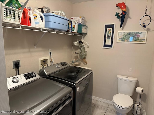 laundry area featuring separate washer and dryer and light tile patterned floors