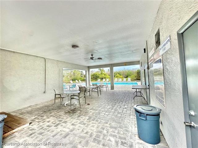 view of patio / terrace with a swimming pool and ceiling fan