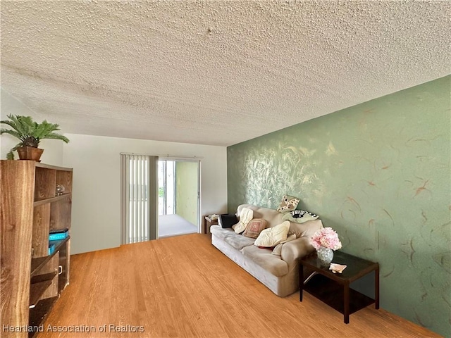 unfurnished living room with a textured ceiling and hardwood / wood-style flooring