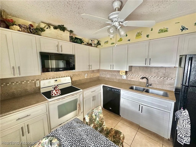 kitchen with black appliances, white cabinetry, light tile patterned flooring, and sink