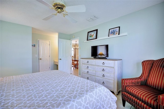 1712 Sunrise Pl, Sebring, FL 33870 - bedroom with light tile patterned flooring, a chandelier, and ceiling fan