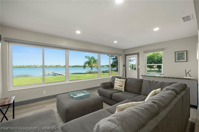 1622 Dinner Dr, Sebring, FL 33870 - living room with visible vents, baseboards, light wood-style flooring, recessed lighting, and a water view